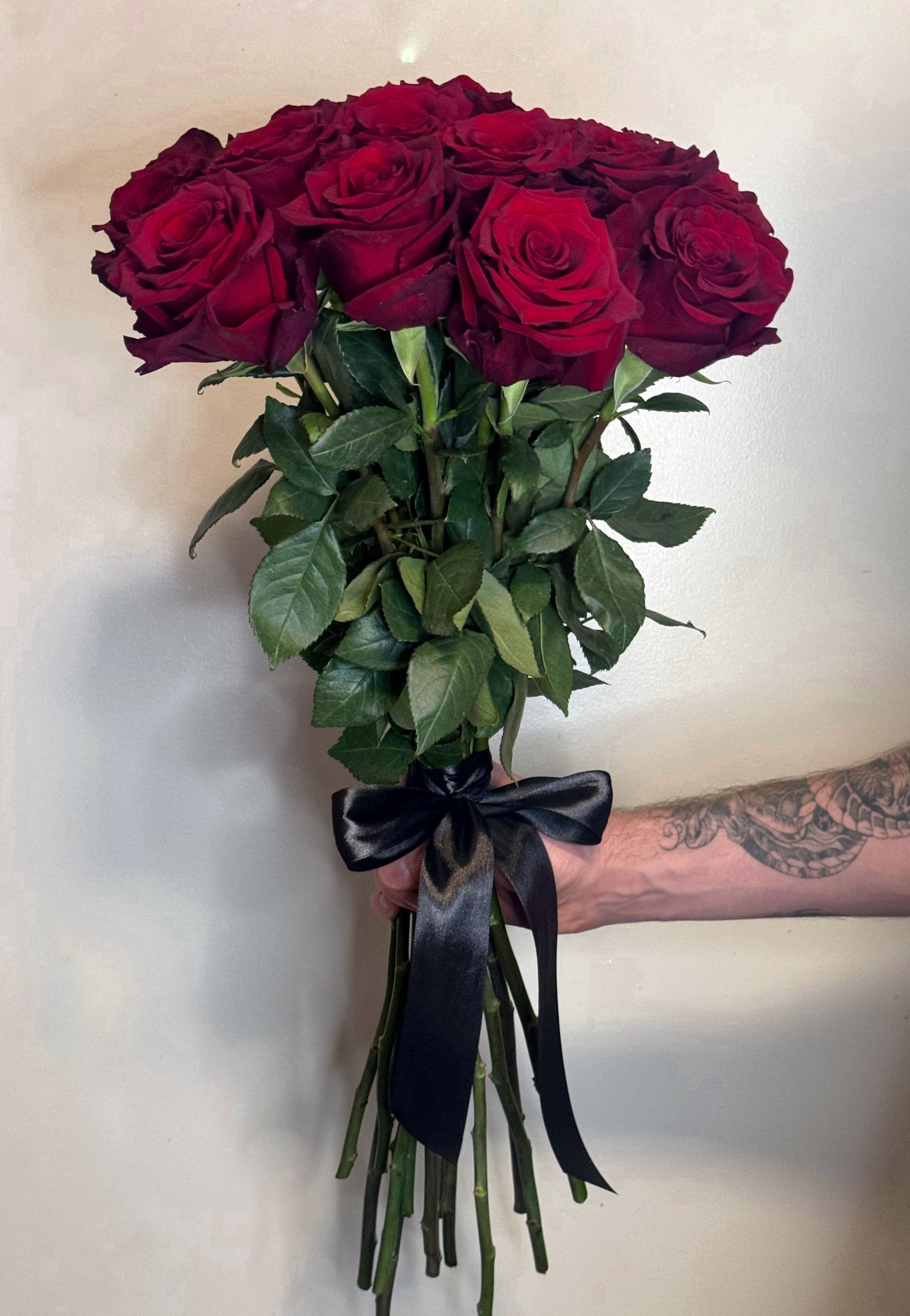 Bouquet of red roses with a black ribbon