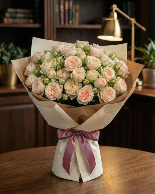 Bouquet of flowers with a purple ribbon on a wooden table in a room setting.